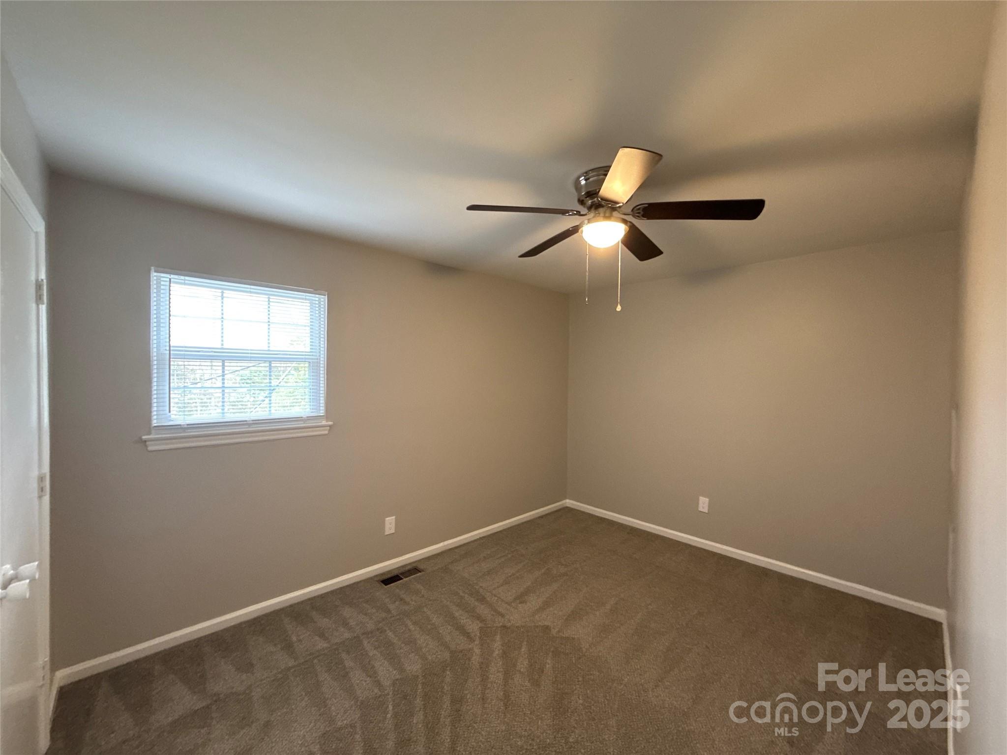 409 Hawley Avenue, Unit 7 Belmont, NC 28012 - Photo 9 of 12 an empty room with a window