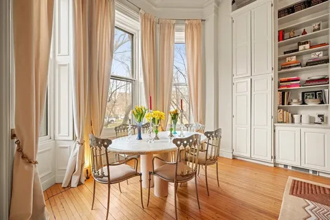 a view of a dining room with furniture and a window