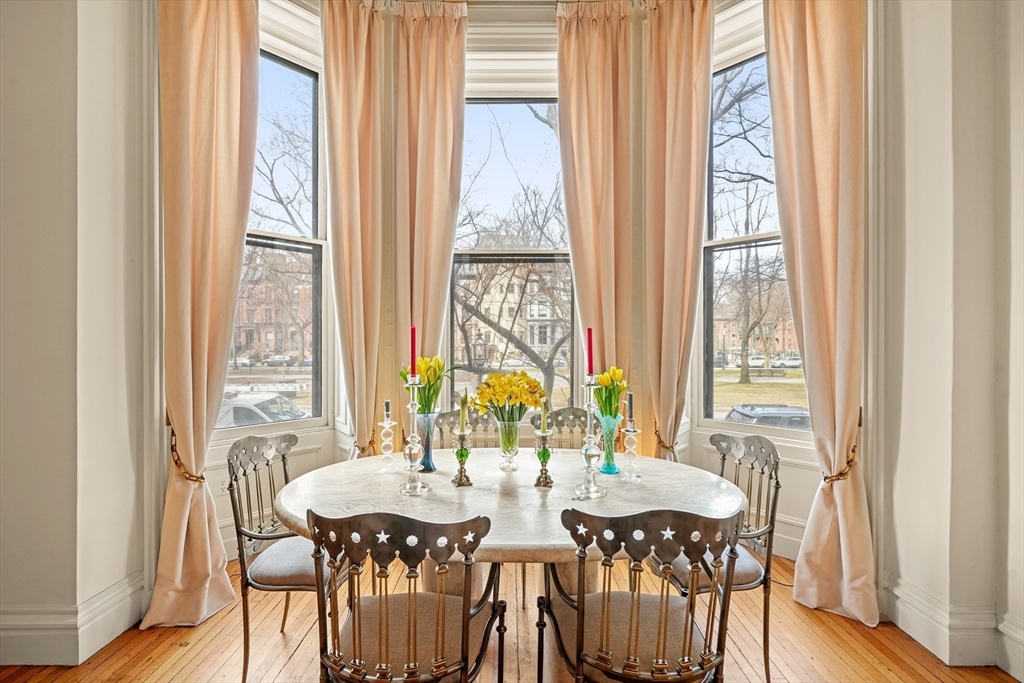 116 Commonwealth Avenue, Unit 1 Boston, MA 02116 - Photo 4 of 27 a view of a dining room with furniture and wooden floor