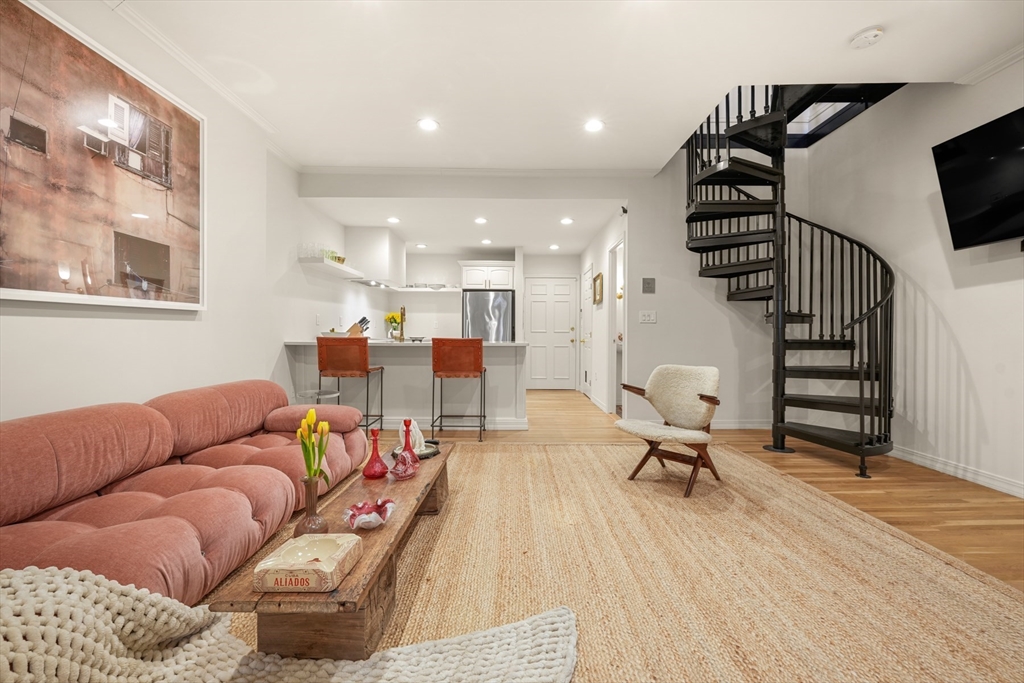 116 Commonwealth Avenue, Unit 1 Boston, MA 02116 - Photo 9 of 27 a living room with furniture and a flat screen tv