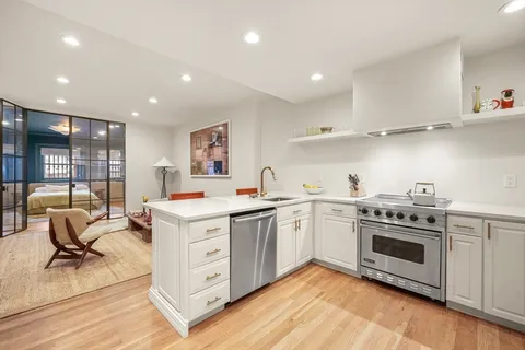 a kitchen with a stove oven and sink