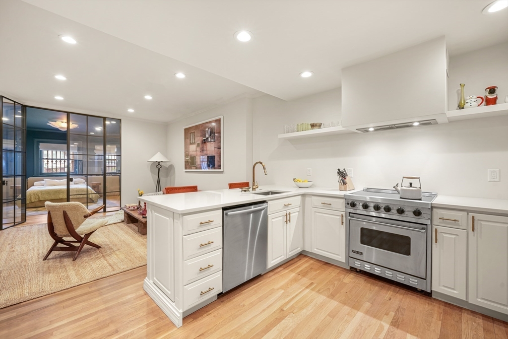 116 Commonwealth Avenue, Unit 1 Boston, MA 02116 - Photo 9 of 28 a kitchen with a stove oven and sink