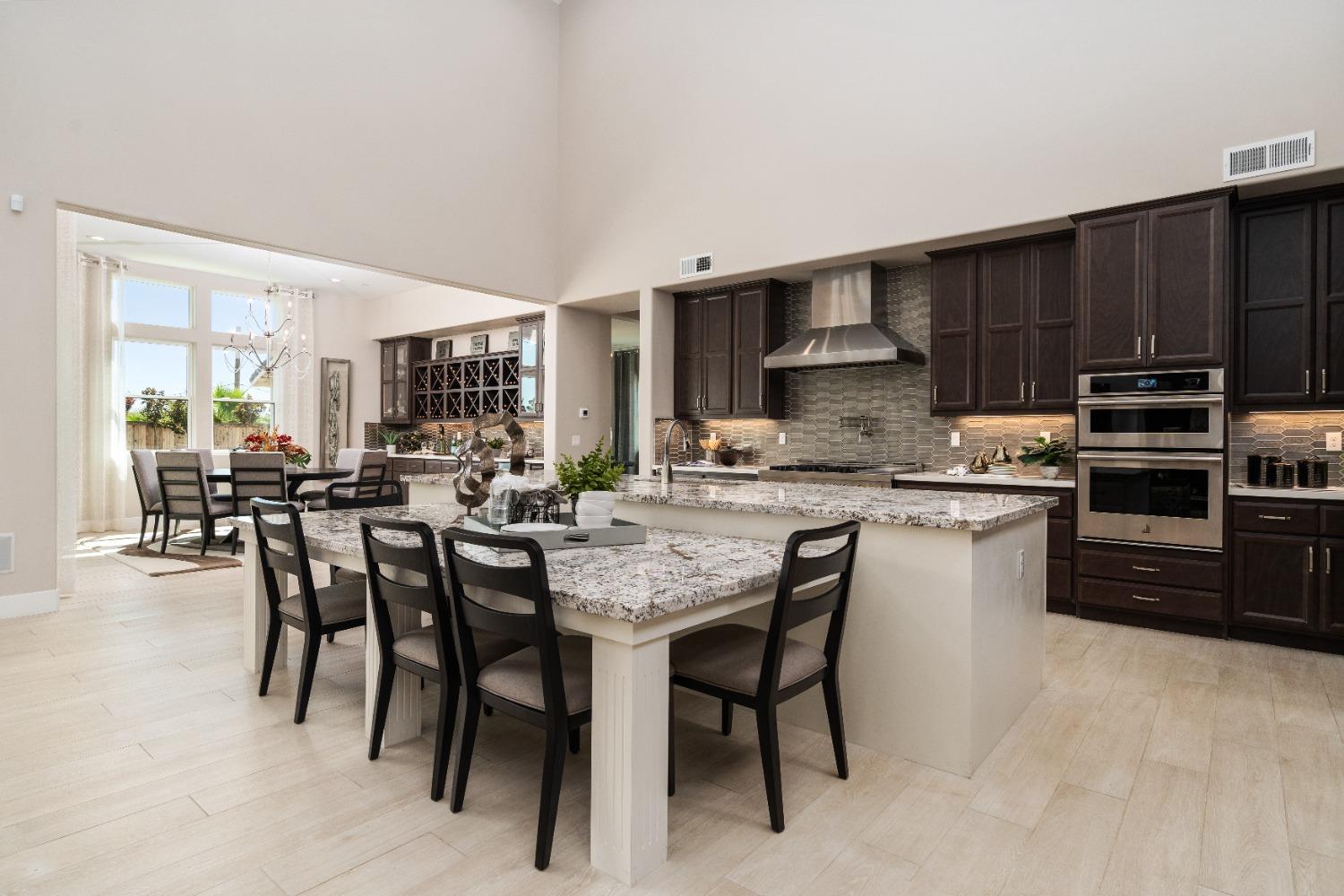 1764 Lester Avenue Clovis, CA 93619 - Photo 13 of 51 a kitchen with stainless steel appliances granite countertop a stove a sink a table and chairs