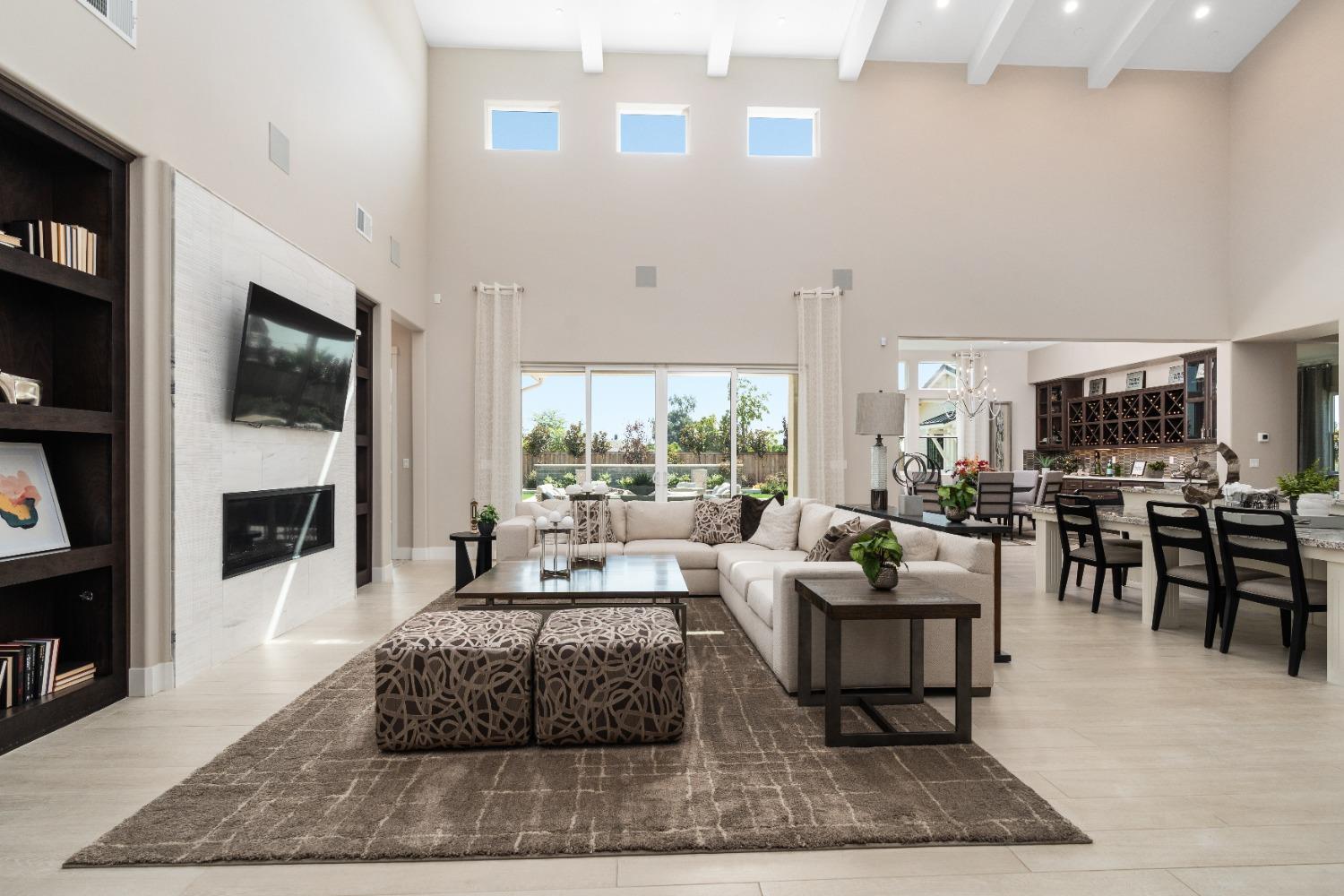 1764 Lester Avenue Clovis, CA 93619 - Photo 22 of 51 a living room with furniture a flat screen tv and a fireplace