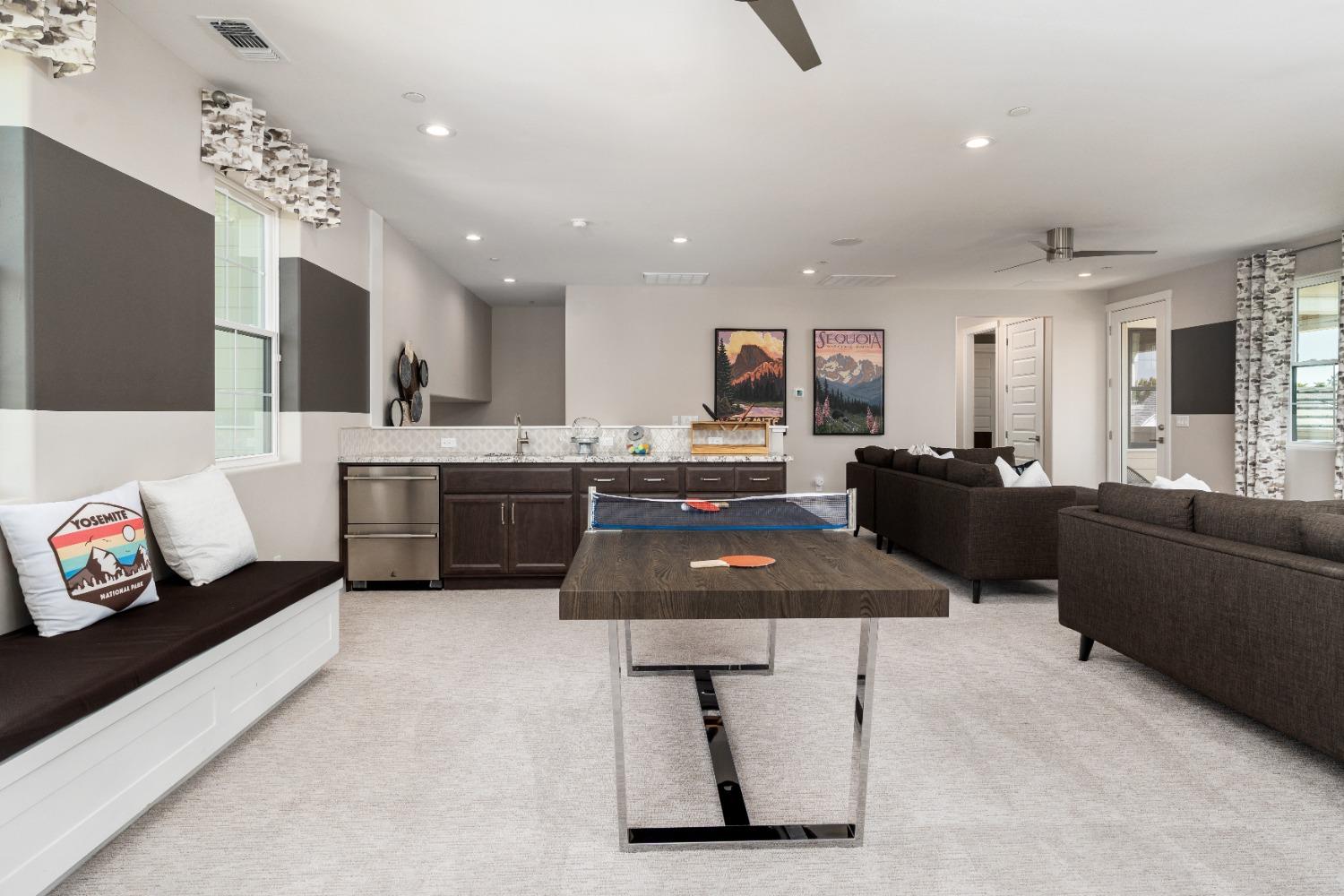 1764 Lester Avenue Clovis, CA 93619 - Photo 27 of 51 a kitchen with stainless steel appliances a stove a refrigerator a sink dishwasher a dining table and chairs with wooden floor