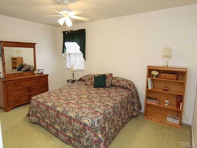 1509 Falls Church Road Raleigh, NC 27609 - Photo 11 of 18 a bedroom with a bed and a dresser