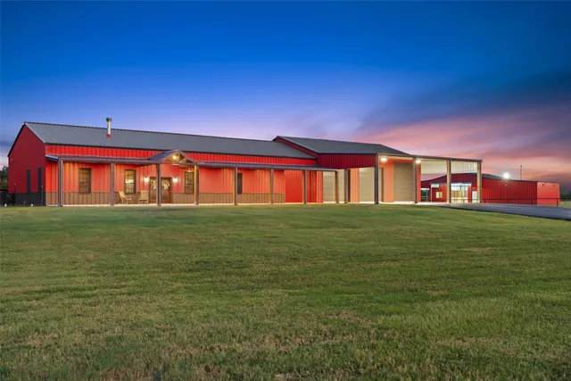 a front view of building with yard and seating area