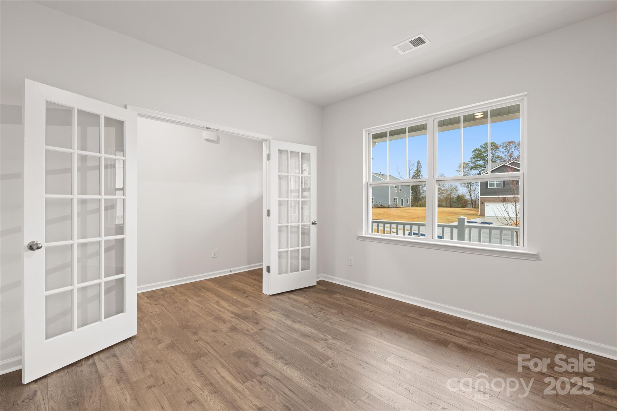 198 Shorthorn Road Fletcher, NC 28732 - Photo 10 of 20 an empty room with wooden floor and windows