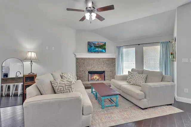 a living room with furniture and a fireplace