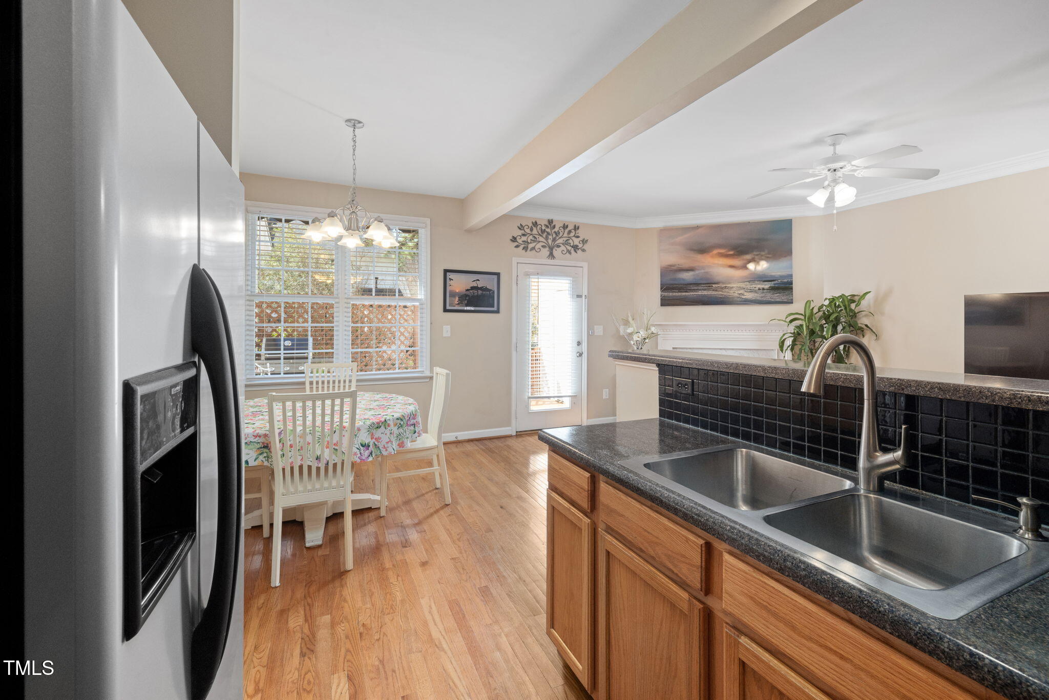 5569 Sea Daisy Drive Raleigh, NC 27606 - Photo 10 of 31 a kitchen with granite countertop a sink chairs and refrigerator