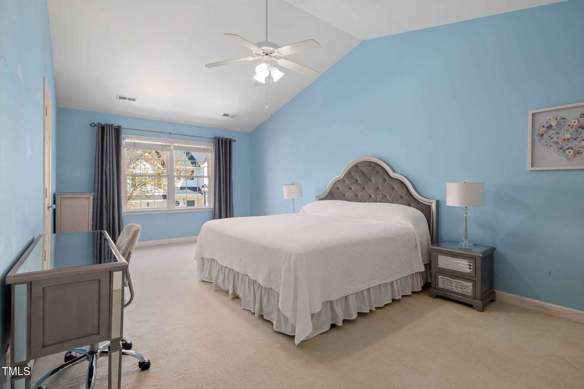 5569 Sea Daisy Drive Raleigh, NC 27606 - Photo 11 of 31 a spacious bedroom with a bed and a table in it