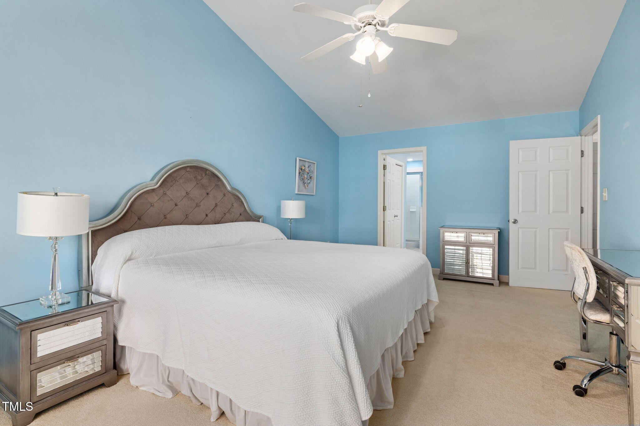 5569 Sea Daisy Drive Raleigh, NC 27606 - Photo 12 of 31 a bedroom with a bed and a chandelier