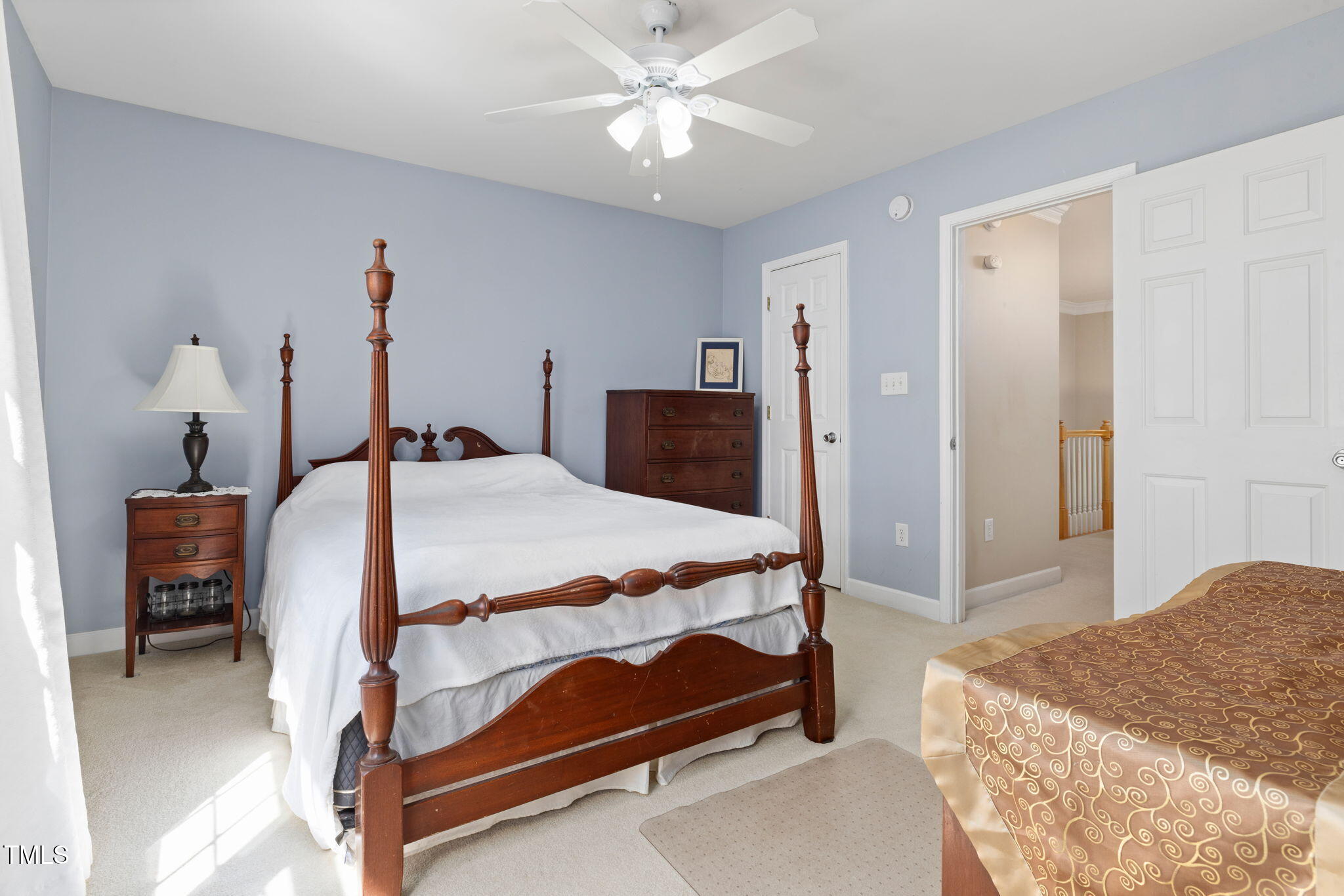 5569 Sea Daisy Drive Raleigh, NC 27606 - Photo 17 of 31 a bedroom with a bed and a chandelier
