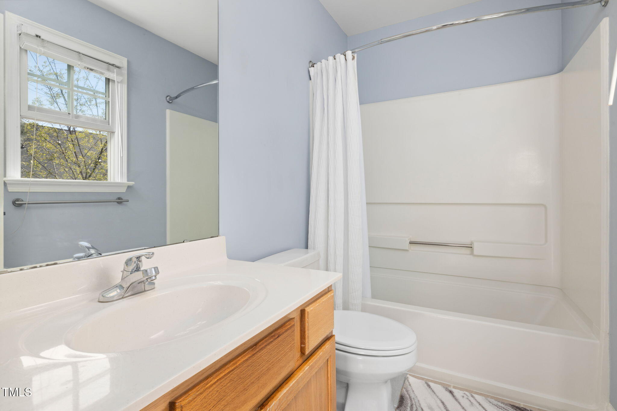 5569 Sea Daisy Drive Raleigh, NC 27606 - Photo 18 of 31 a bathroom with a sink toilet and shower