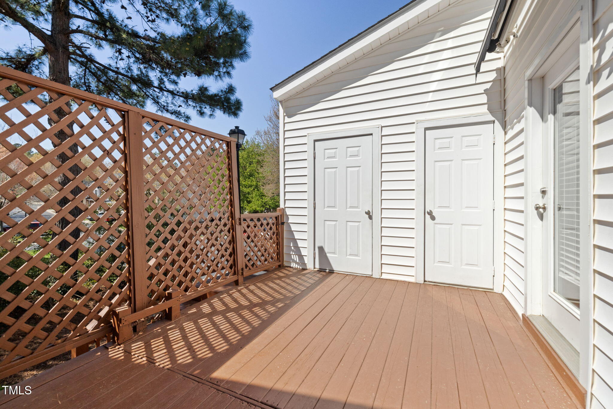 5569 Sea Daisy Drive Raleigh, NC 27606 - Photo 22 of 31 a view of a porch with wooden floor and fence