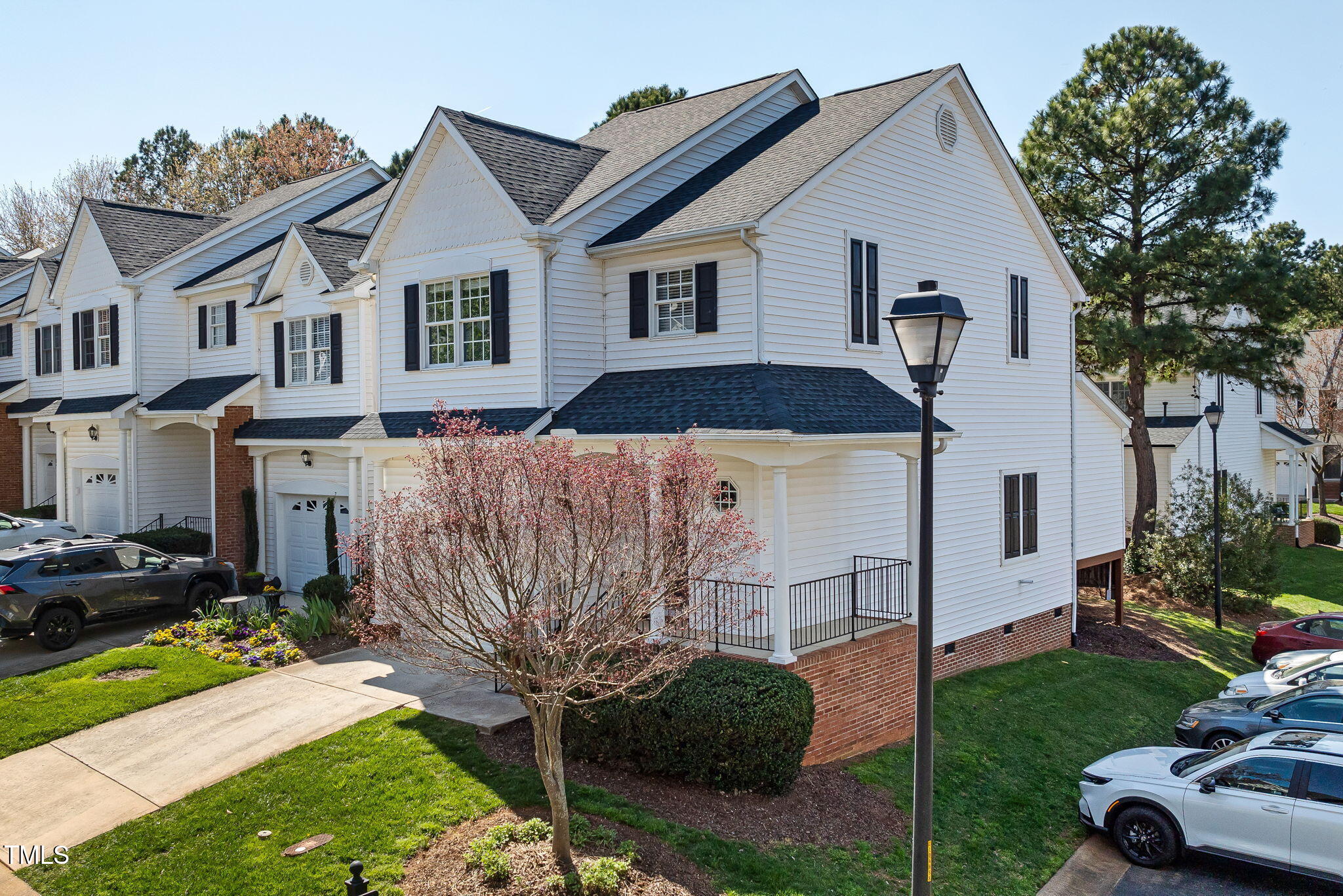 5569 Sea Daisy Drive Raleigh, NC 27606 - Photo 2 of 31 a view of a white house in front of a yard with potted plants