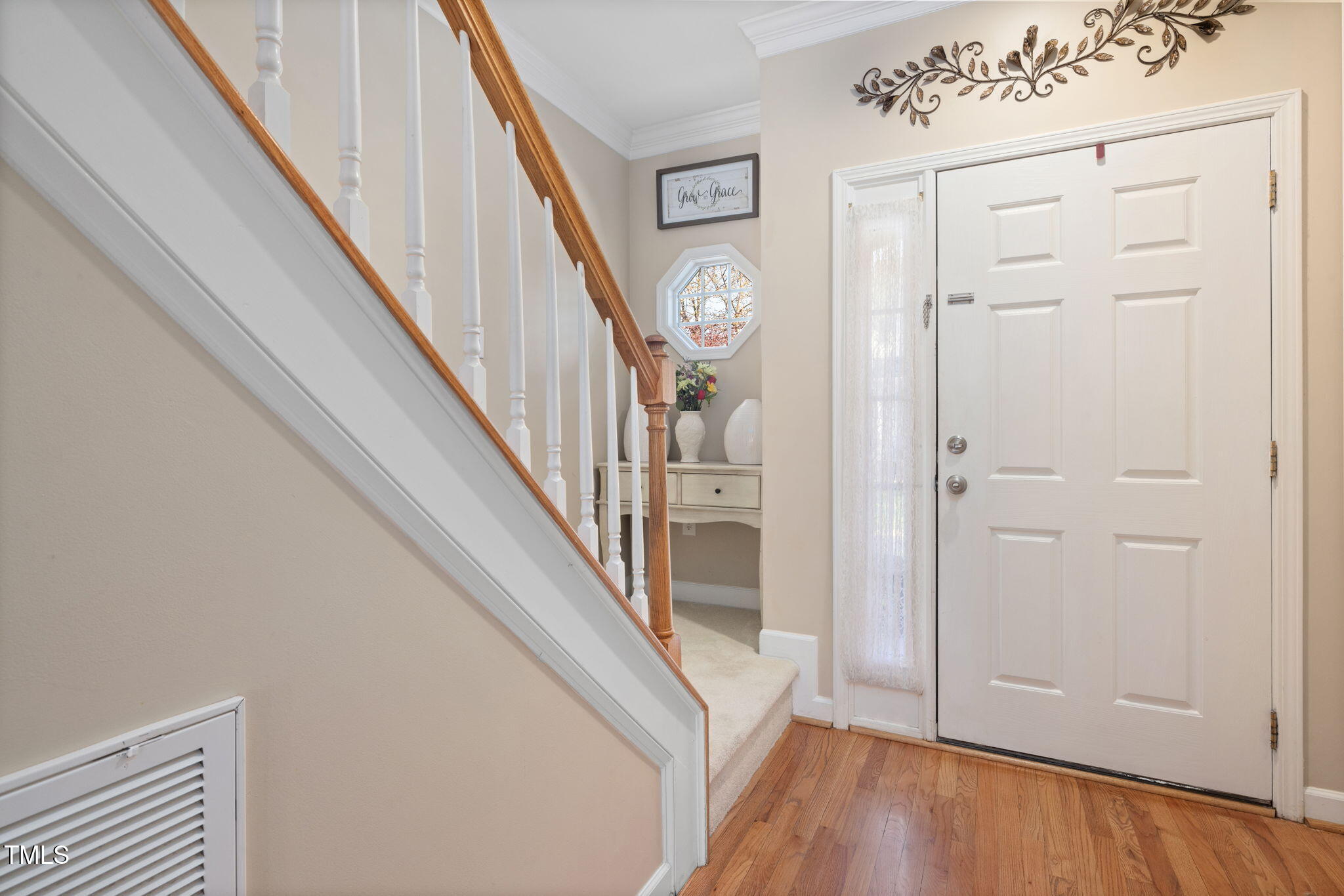 5569 Sea Daisy Drive Raleigh, NC 27606 - Photo 4 of 31 a view of entryway with wooden floor and stairs