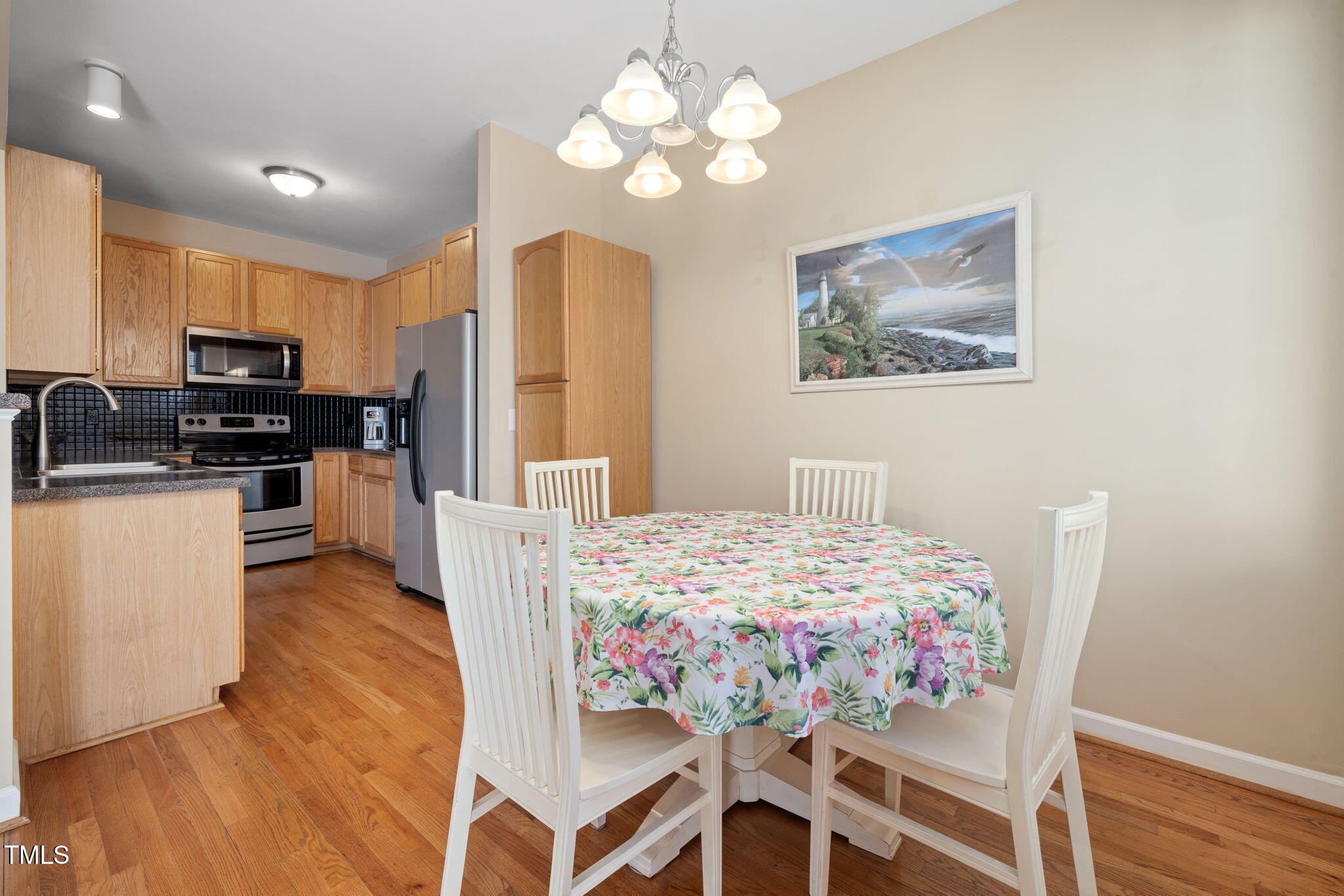 5569 Sea Daisy Drive Raleigh, NC 27606 - Photo 8 of 31 a bedroom with a bed and a chandelier