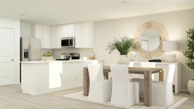 a kitchen with stainless steel appliances granite countertop a white cabinets a stove a sink and a refrigerator