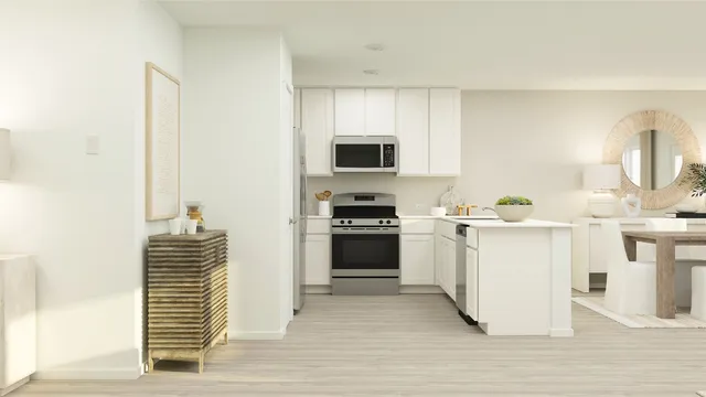 a kitchen with a sink and a stove top oven with wooden floor