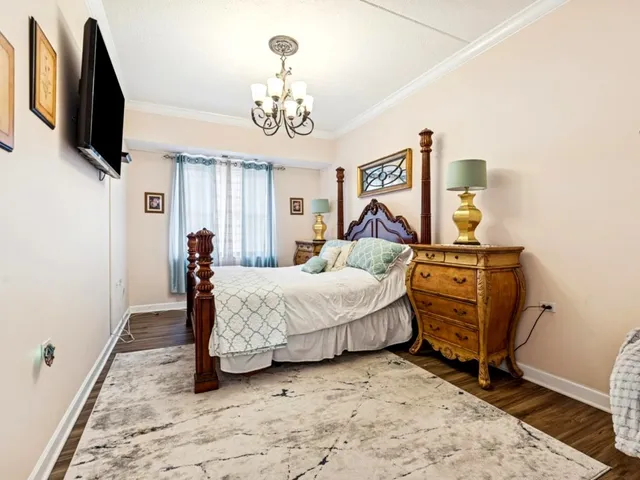 a bed room with a bed window and a flat screen tv