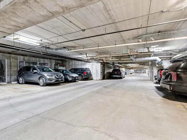 a view of parking garage with cars