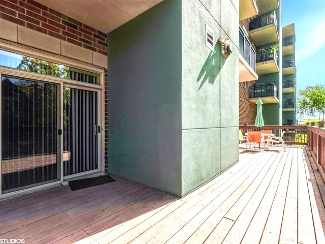 a view of balcony with floor to ceiling windows