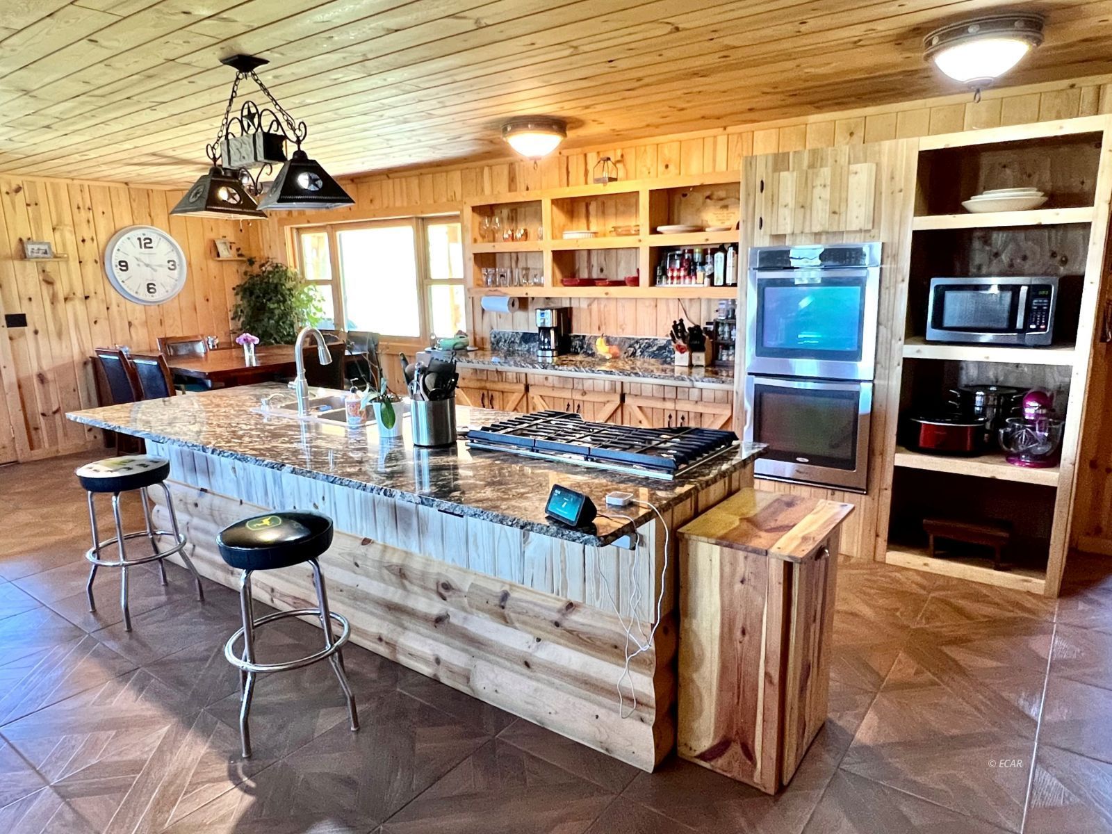 4513 Starr Valley Road Deeth, NV 89823 - Photo 4 of 49 a kitchen with stainless steel appliances kitchen island granite countertop a table and chairs in it