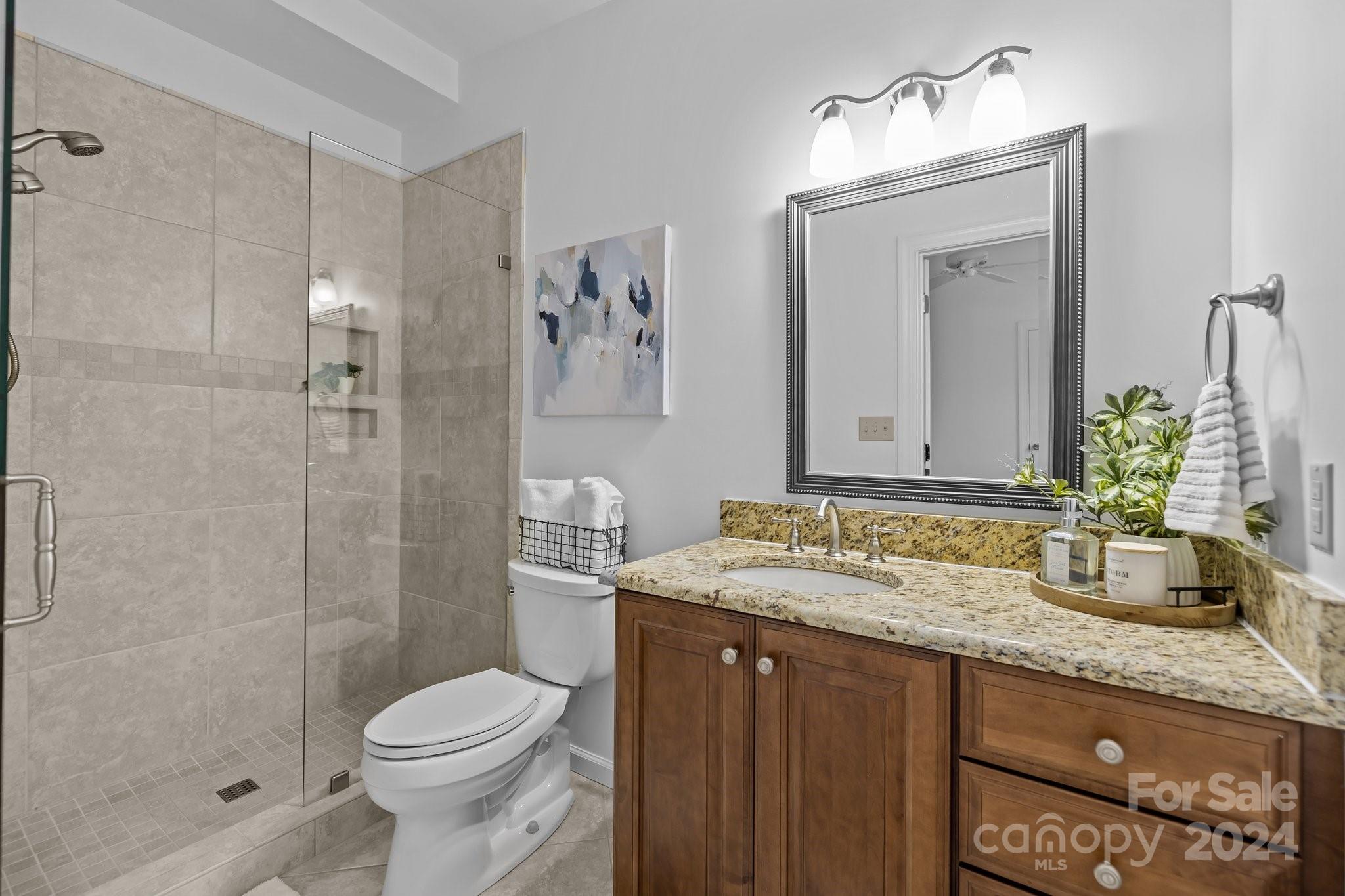 10508 Misty Ridge Lane Charlotte, NC 28277 - Photo 21 of 32 a bathroom with a granite countertop sink toilet and shower