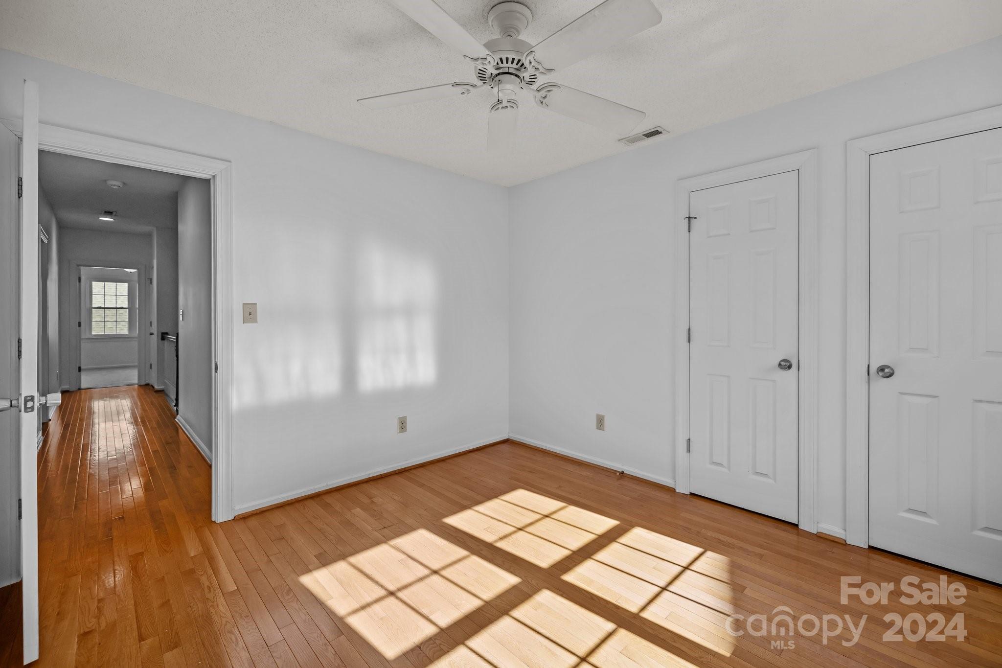 10508 Misty Ridge Lane Charlotte, NC 28277 - Photo 23 of 32 a view of empty room with wooden floor and fan
