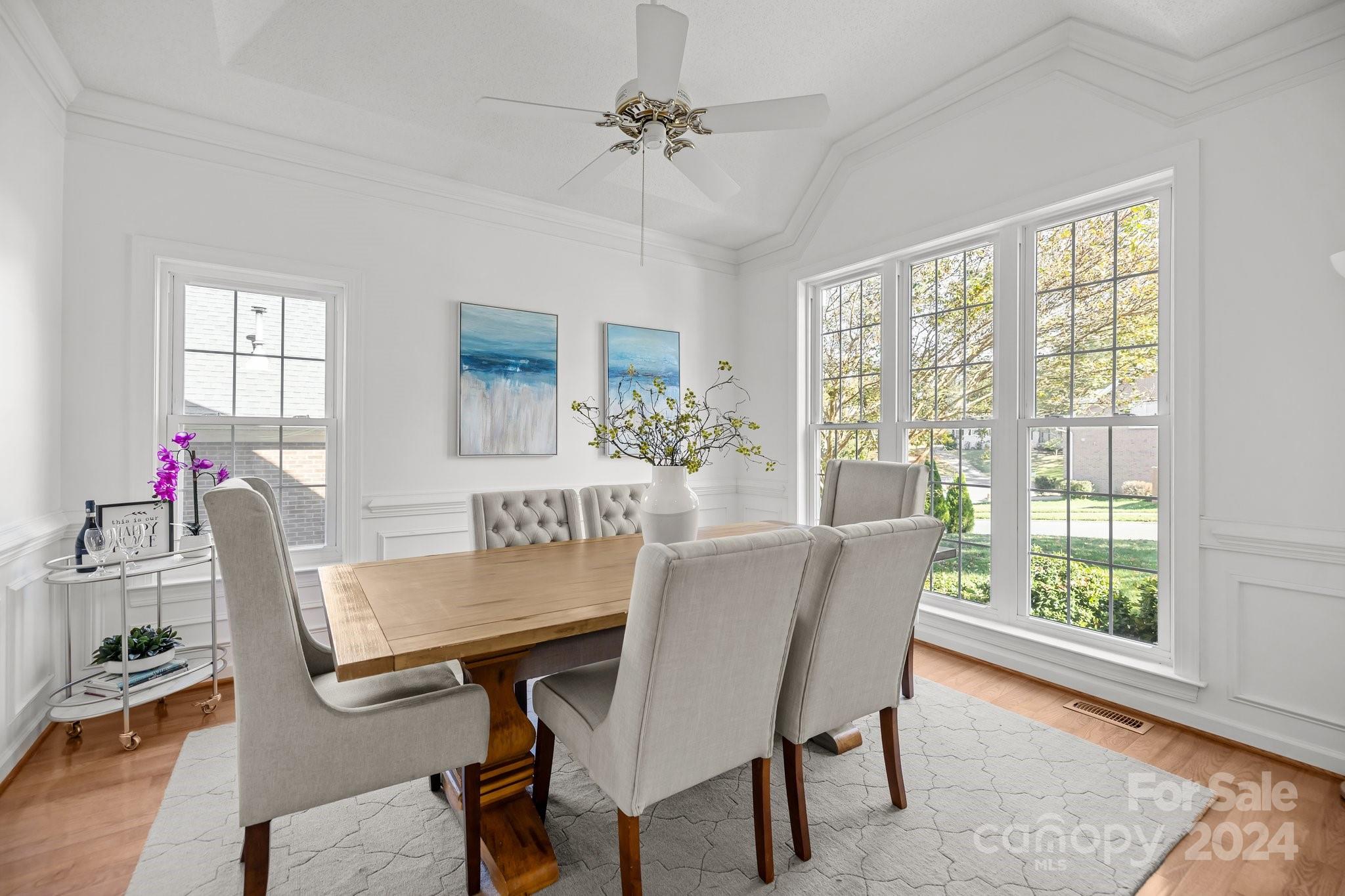 10508 Misty Ridge Lane Charlotte, NC 28277 - Photo 4 of 32 a dining room with furniture potted plants and wooden floor