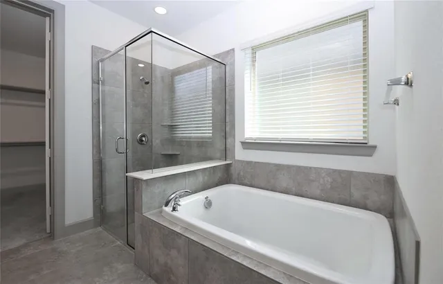 a bathroom with a bathtub and shower