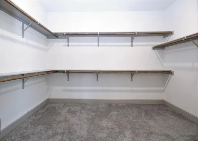 an empty room with a empty space and windows