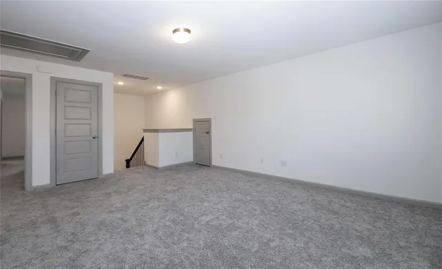 an empty room with a empty space and windows