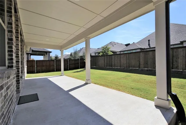 a view of a house with backyard and porch