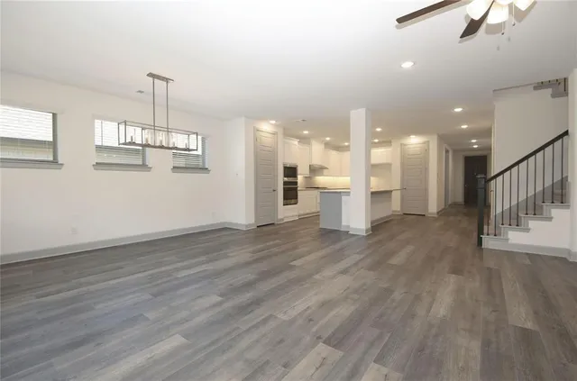 a view of a room with wooden floor and windows