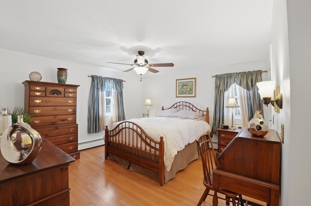 54 Sagamore Road Seekonk, MA 02771 - Photo 22 of 35 a bedroom with a bed and a chandelier
