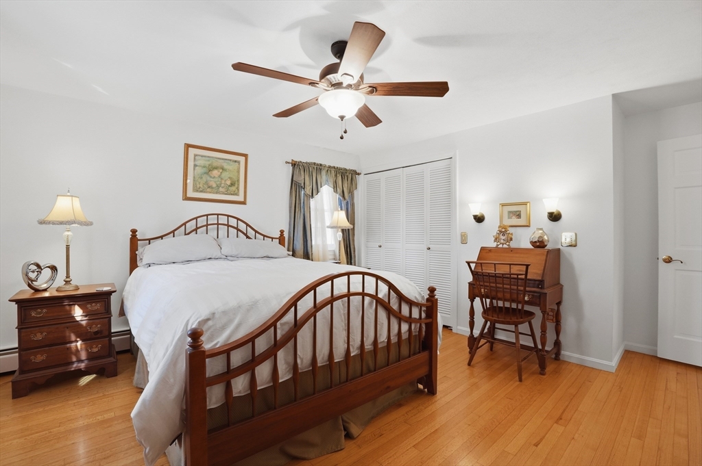 54 Sagamore Road Seekonk, MA 02771 - Photo 23 of 35 a bedroom with a bed and a chandelier