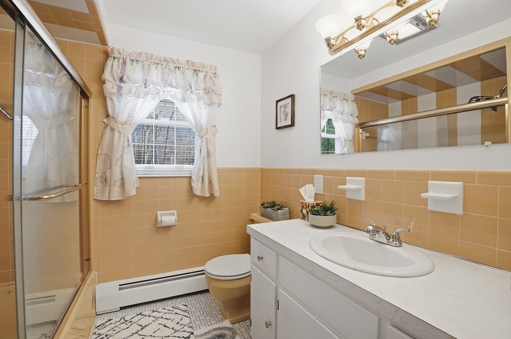 54 Sagamore Road Seekonk, MA 02771 - Photo 28 of 35 a bathroom with a sink a toilet and shower