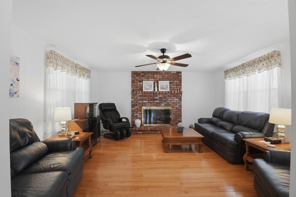 54 Sagamore Road Seekonk, MA 02771 - Photo 4 of 35 a living room with furniture ceiling fan and a fireplace