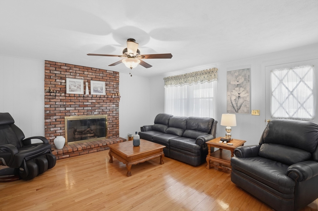 54 Sagamore Road Seekonk, MA 02771 - Photo 6 of 35 a living room with furniture a fireplace and a flat screen tv
