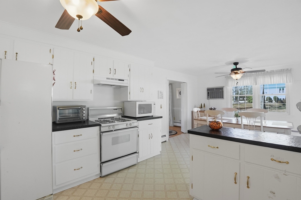 54 Sagamore Road Seekonk, MA 02771 - Photo 8 of 35 a kitchen with white cabinets and appliances