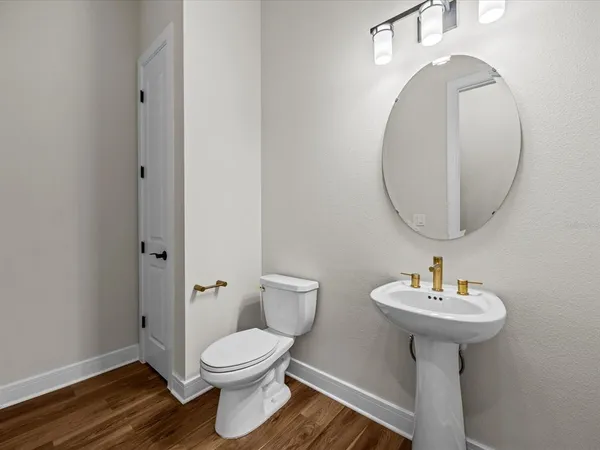 a bathroom with a sink toilet and a mirror
