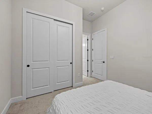 a bedroom with a bed and a bathroom