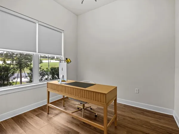a view of a room with wooden floor and windows