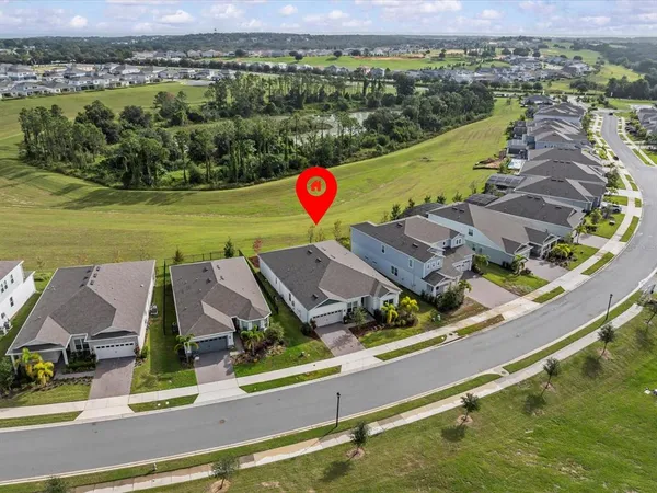 an aerial view of residential houses with outdoor space and swimming pool