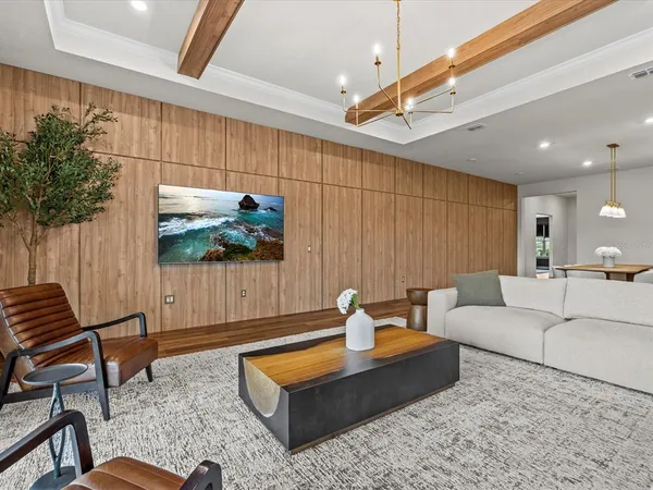 a living room with patio furniture and a potted plant