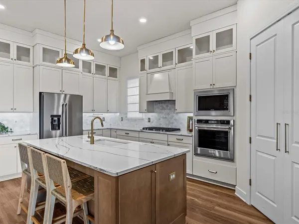 a kitchen with a stove a sink and a refrigerator