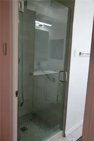 a bathroom with a glass shower door