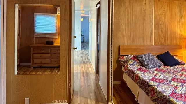a bed sitting in a bedroom next to a bathroom